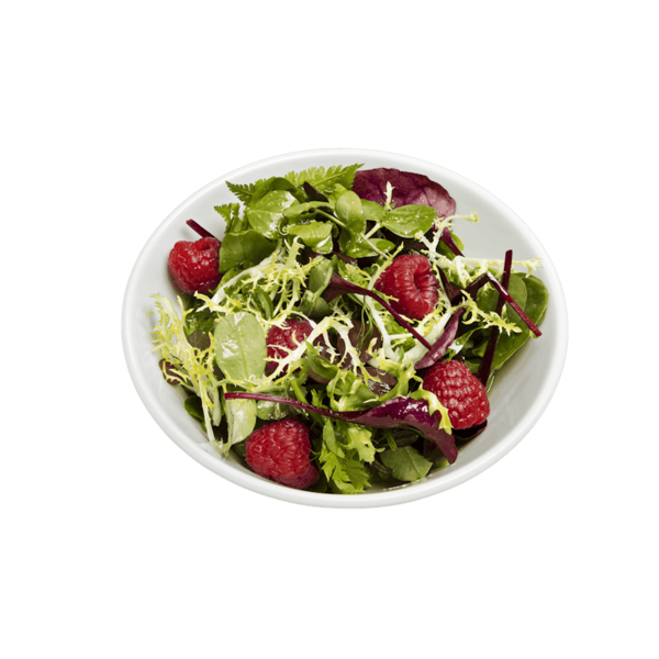 Weber Porzellanschüssel mit frischem Salat auf grünem Hintergrund