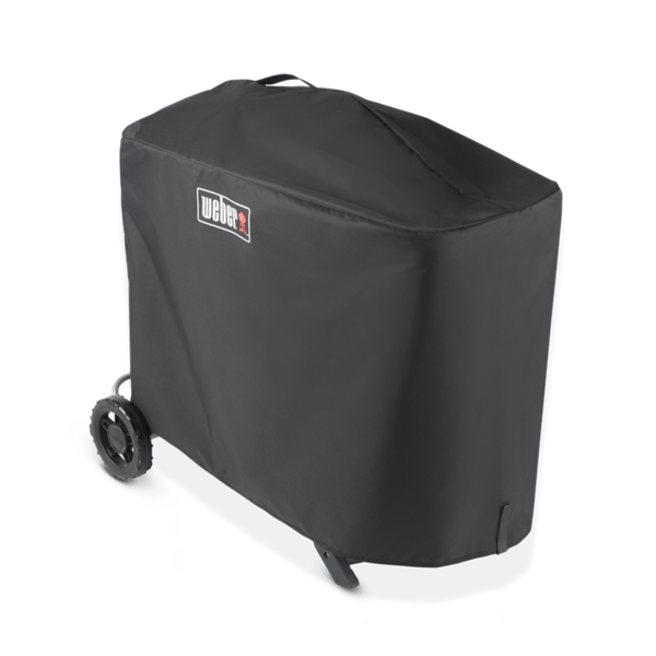 Weber Traveler Premium Abdeckhaube über einem Grill mit sichtbarem Weber-Logo