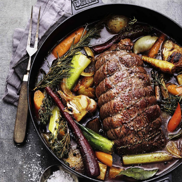 Gebratener Rinderbraten mit Gemüse und Kräutern im Dutch Oven