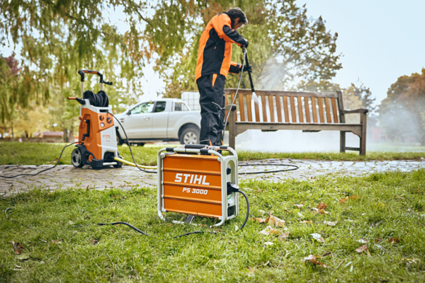 Mann verwendet Hochdruckreiniger im Garten, angeschlossen an STIHL PS 3000