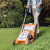Person verwendet STIHL RMA 339 Rasenmäher in einem grünen Garten