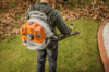 Mann benutzt STIHL BR 350 Laubbläser in einem Garten mit Herbstlaub