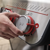 Hand adjusts red control knob on Weber SPIRIT EP-325 GBS Gasgrill