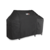Weber Premium Abdeckhaube Summit FS38 über einem großen Grill