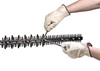 Person adjusts hedge trimmer blades with tools wearing STIHL gloves