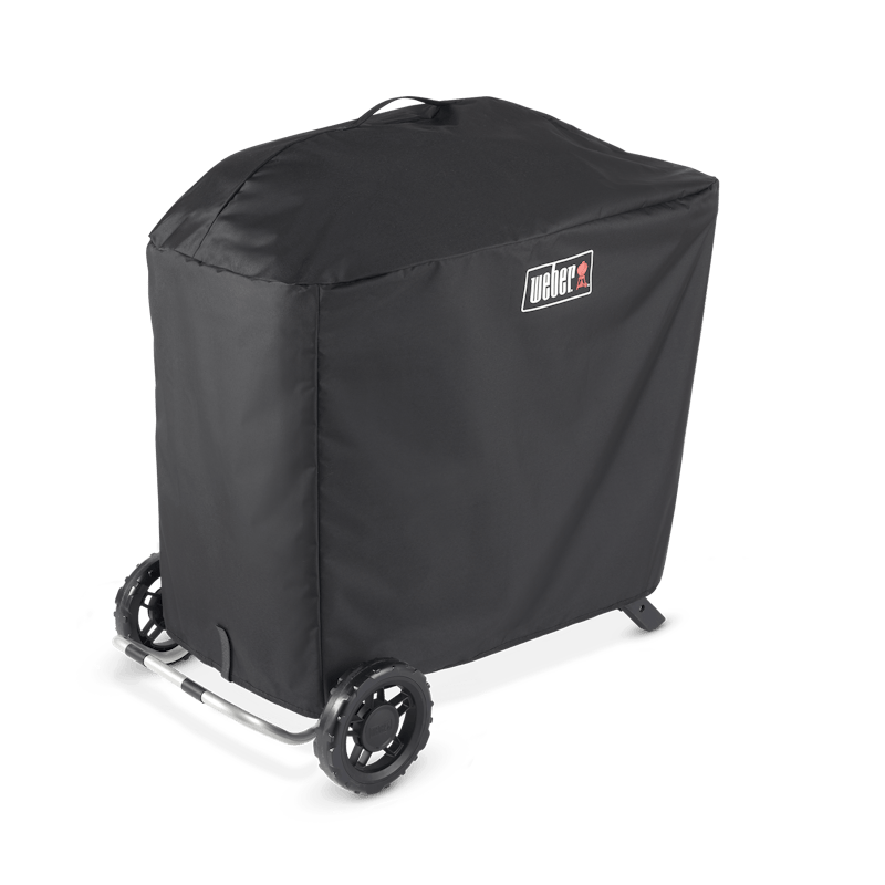 Schwarze Weber Traveler Premium Abdeckhaube über einem mobilen Grill