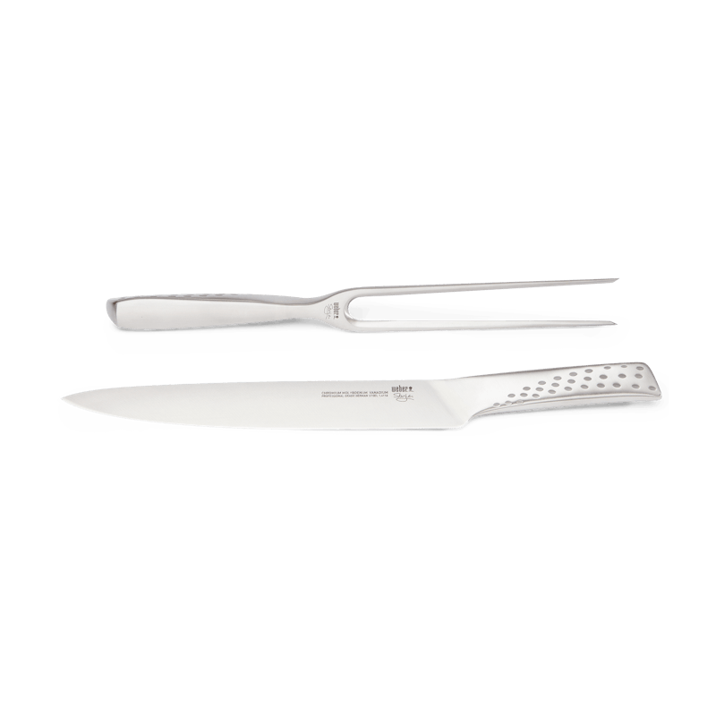 Edelstahl Tranchierbesteck-Set bestehend aus Messer und Gabel auf einfarbigem Hintergrund