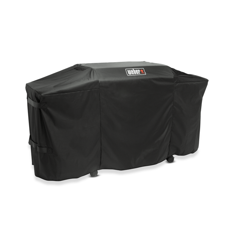 Weber Premium Abdeckhaube auf einer Plancha mit sichtbarem Logo und Klettbändern