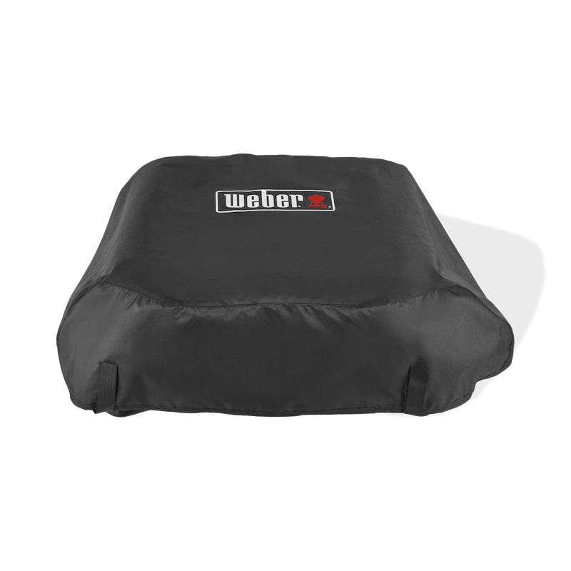 Weber Prem. Abdeckhaube Slate 43cm über einer Plancha mit Weber-Logo