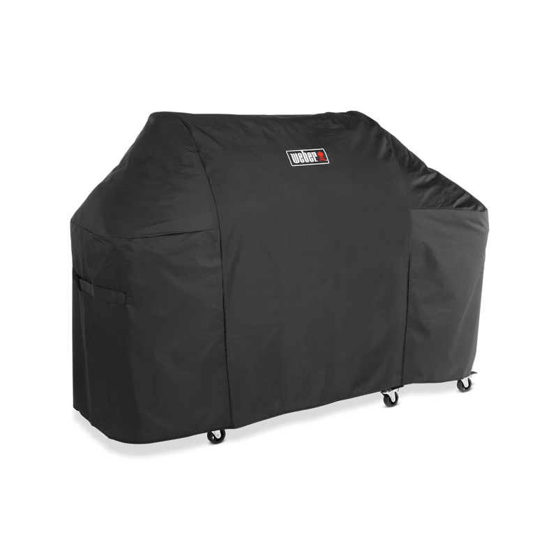 Weber Premium Abdeckhaube Summit FS38 über einem großen Grill